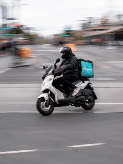 The man in black jacket during the day on the road to ride a motorcycle
